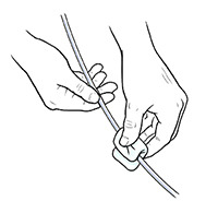 Closeup of hands cleaning catheter.